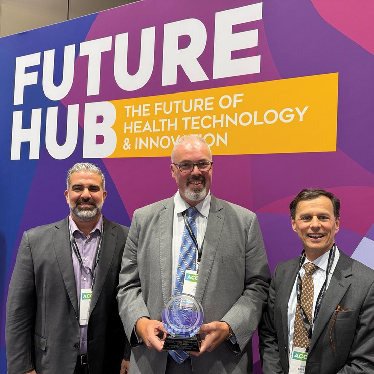 Dikran Tourian, Omer Inan, PhD, holding the People’s Choice award, and Kenneth Civello, MD, MPH, in front of the ACC Future Hub backdrop.